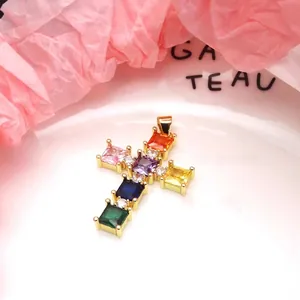 Macro detail of a colorful square zirconia cross pendant in a polished gold finish