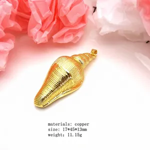 Macro detail view of a polished gold copper conch shell pendant with ridged texture