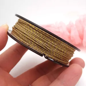 Detailed view of 0.8mm gold-threaded twisted cotton cord for DIY jewelry making