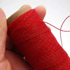 Close-up of 0.4mm red gold-flecked waxed thread for DIY jewelry weaving