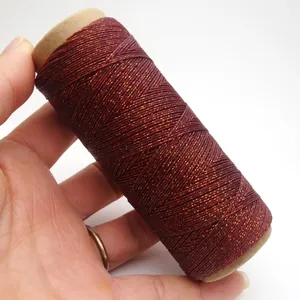 Detailed view of 0.4mm reddish-brown waxed cord with fine gold metallic flecks