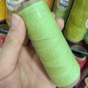 Detail view of lime green 0.4mm gold-added braided waxed thread for DIY jewelry making