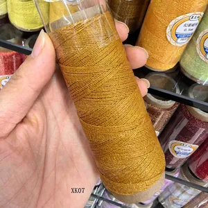 Macro detail view of 0.4mm metallic gold wax thread spool for DIY jewelry crafts.