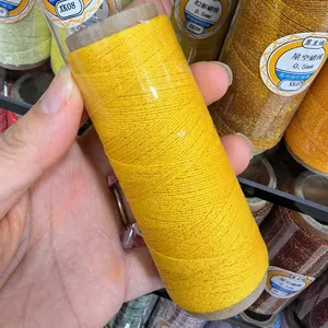 Detailed view of yellow wax thread with gold wire, 0.5mm cord for DIY jewelry braiding