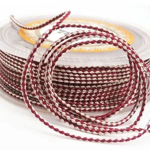 Close-up of 1.5mm burgundy and beige braided dragon pattern cord for jewelry making