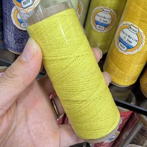 Close-up of yellow 0.5mm braided wax thread with gold glitter for DIY jewelry