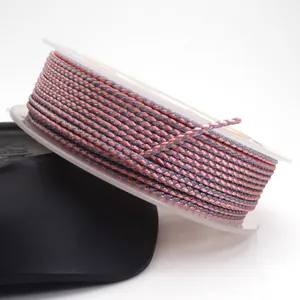 Detailed macro view of 1.5mm pink and grey dragon pattern braided cord wound on a clear spool.