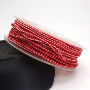 Close-up of 1.5mm red dragon pattern braided cord on a transparent plastic spool