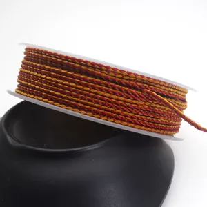 Detail showing 1.5mm red and gold dragon pattern mixed color braided cord on spool