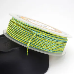 Detail view of 1.5mm yellow and turquoise dragon pattern braided cord for jewelry.