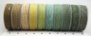 Macro view of 10 colorful hand-twisted cotton cords featuring gold metallic thread accents