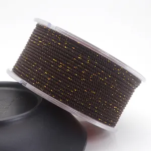 Detailed view of 1.5mm dark brown braided Milan cord featuring gold metallic thread accents