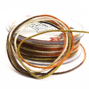 Close-up detail of 1.2mm variegated cotton cord with metallic gold thread on a spool