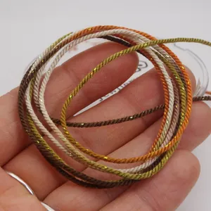 Macro detail of 1.2mm gold-added cotton cord with gradient color weaving texture