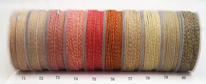 Detailed view of various color-coded hand-twisted cotton cords with gold thread for DIY