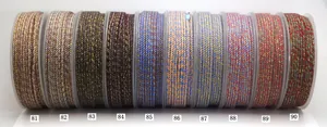 Macro view of multi-colored hand-twisted cotton cords with gold metallic thread details
