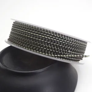 Detailed view of 1.5mm green and black braided dragon pattern cord on a clear spool