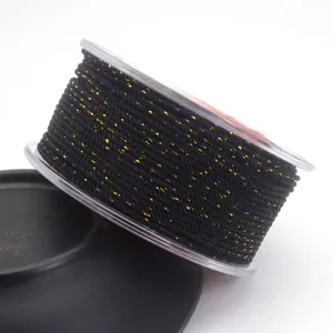 Detail view of 1.5mm black Milan cord woven with gold metallic thread for jewelry making