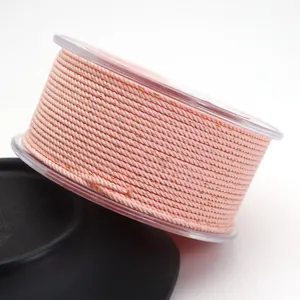 Macro detail of 1.5mm peach pink Milan rope with gold metallic silk for DIY jewelry