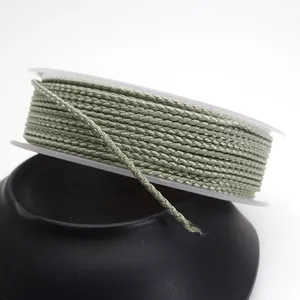 Detailed view of 1.5mm light green dragon pattern braided cord on a white spool