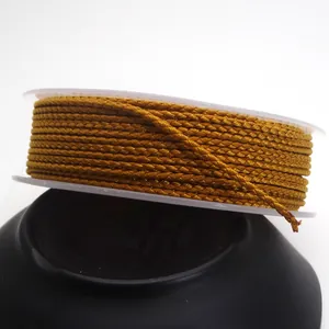 Close-up of 1.5mm golden braided dragon pattern cord for DIY jewelry making and crafts