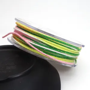 Close-up of 1.2mm rainbow gradient cotton thread with metallic gold glitter for DIY