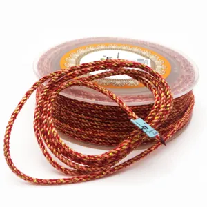 Braided red and gold cotton cord spool for DIY jewelry making necklaces and bracelets.