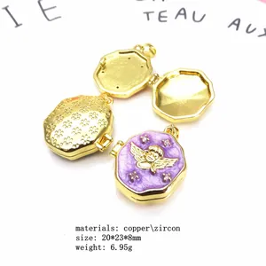 Detailed view of gold-plated copper angel locket with purple enamel and zircon inlay