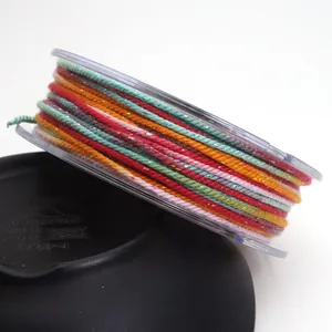 Close-up of 1.2mm colorful braided cotton cord with metallic gold thread on spool.