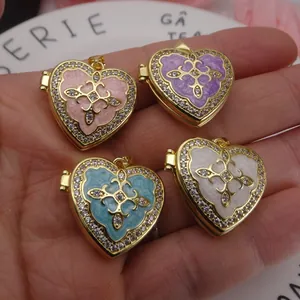 Macro view of gold-plated heart locket pendants featuring enamel centers and zircon.
