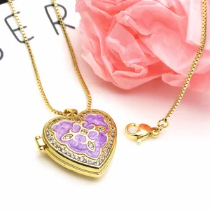 Close-up detail of gold heart locket necklace featuring purple enamel and sparkling CZ stones.