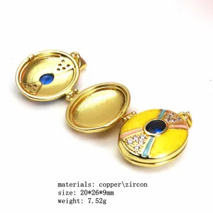 Close-up of open three-fold gold-plated locket pendant with zircon and yellow enamel.