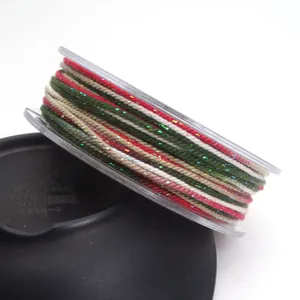 Close-up of 1.2mm multi-colored cotton cord with gold thread wound on a clear spool