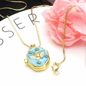 Detail view of a gold-plated octagonal angel locket necklace with blue enamel and zircons