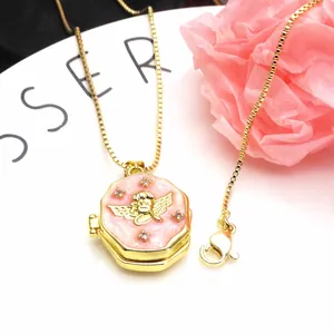 Macro view of gold-plated octagonal angel locket necklace with pink enamel and zircons