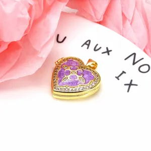 Detailed macro shot of a heart-shaped purple enamel locket inlaid with zircon stones.