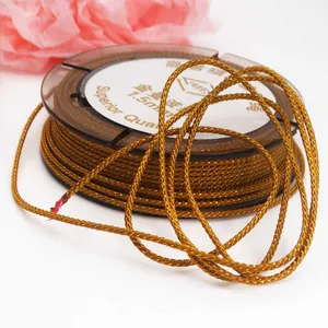 1.5mm golden metallic Manbo cord for DIY jewelry braiding on a brown spool
