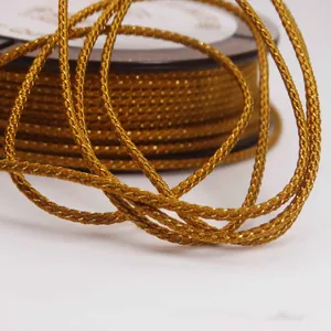 Close-up macro view of golden braided Mambo cord showing detailed metallic thread texture