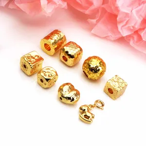 Close-up of gold-plated dragon scale and ice crack beads for DIY jewelry making