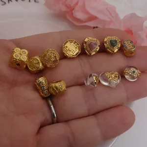 Detailed assortment of gold-plated spacer beads with zircon for DIY bracelets and necklaces.