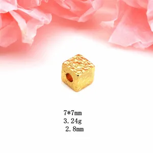 Macro view of textured golden cube spacer bead with dimensions 7x7mm for DIY jewelry