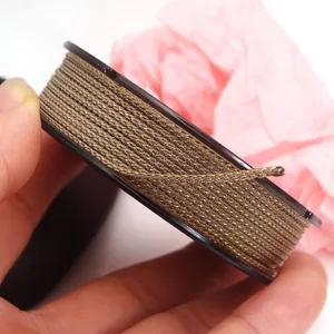 Macro detail of brown and gold braided Manbo cord for DIY jewelry bracelet making