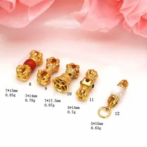 Detailed view of assorted golden Vajra pestle charms with size and weight measurements
