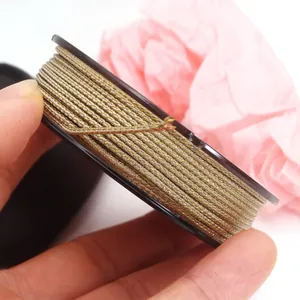 Detailed view of beige Mambo weaving cord with gold wire for DIY jewelry making