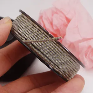 Detailed view of grey and gold braided Mambo cord for DIY jewelry making and crafts.
