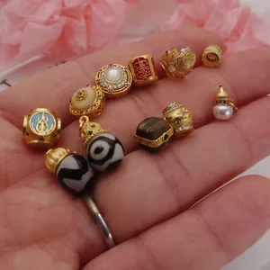 Assorted gold-plated DIY jewelry charms featuring lotus, gourd, and traditional Bagua patterns.