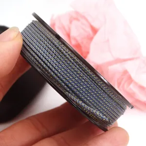 Detailed view of grey braided cord with gold metallic thread for DIY jewelry weaving