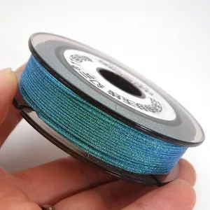Close-up of cyan shimmering 0.85mm weaving cord on a spool for jewelry DIY craft projects
