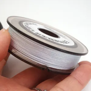 Macro detail of 0.85mm iridescent braided jade thread spool for DIY jewelry making