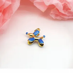 Close-up of a blue enamel balloon dog charm with gold-tone accents for jewelry making